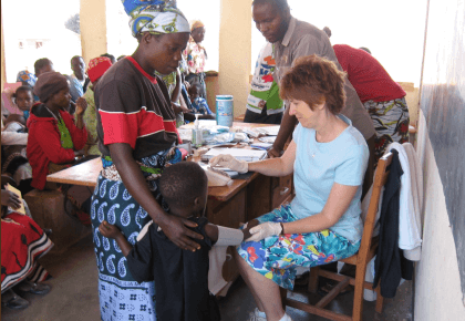 a family receiving health advice from a volunteer
