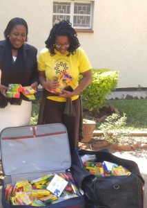Giving Dorika crayons for crisis nurseries