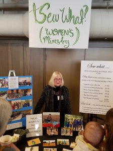Sherry Hall at a booth advertising the Sew What women's ministry