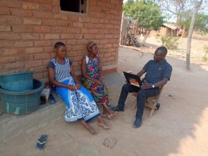 Tionge assessing a household's need for scholarship support